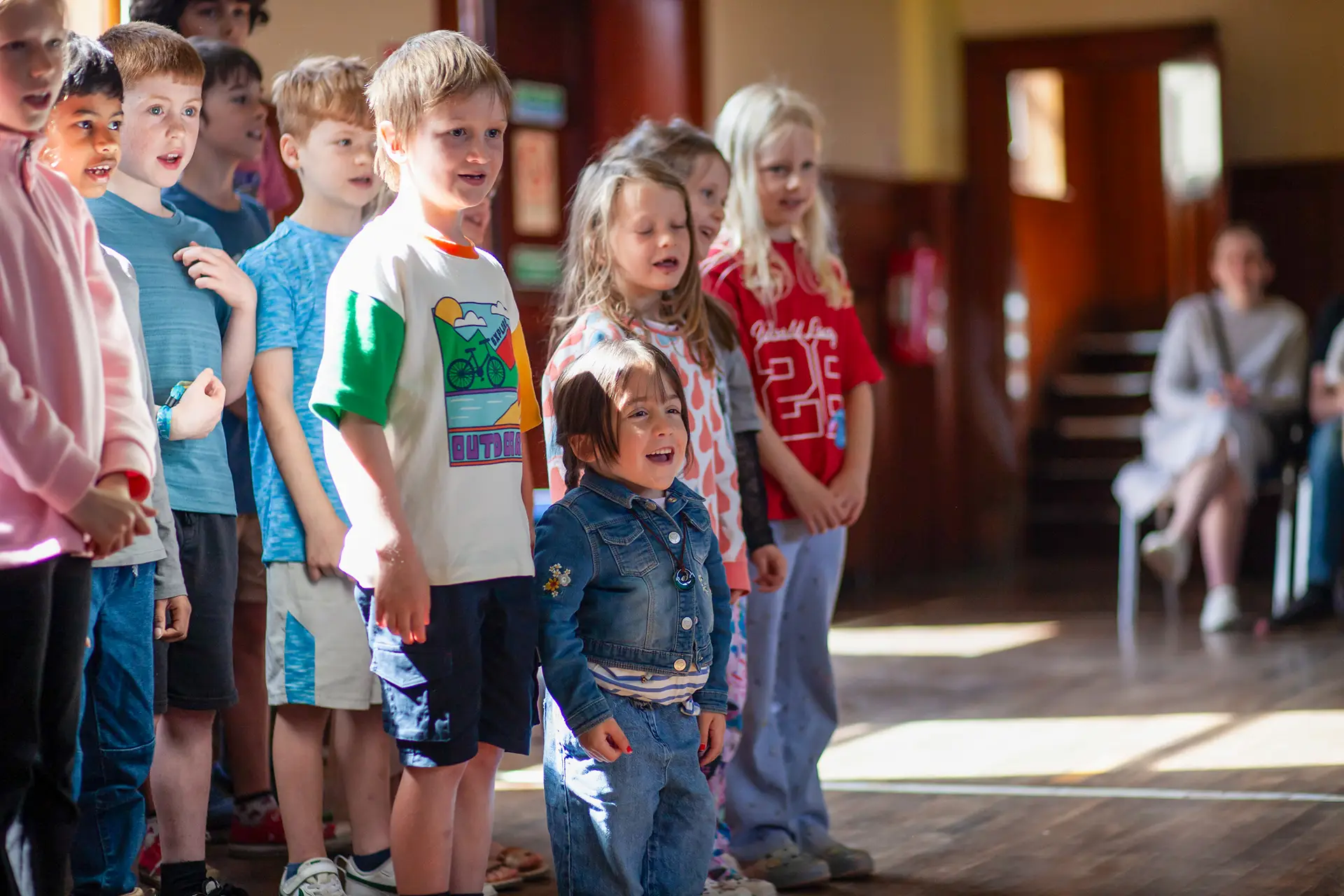 Children singing together at the community day in McLaren Hall